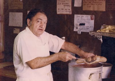 Pat Santoro making a meatball Sandwich, 1956